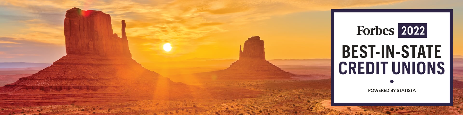 A breathtaking sunset over the Arizona desert mountains, featuring the prestigious 'Forbes 2022 Best-in-State Credit Unions, Powered by Statista' black and white graphic centered within the scenic landscape.