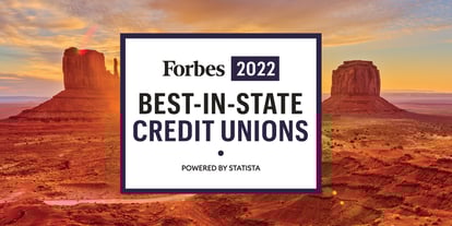 A breathtaking sunset over the Arizona desert mountains, featuring the prestigious 'Forbes 2022 Best-in-State Credit Unions, Powered by Statista' black and white graphic centered within the scenic landscape.